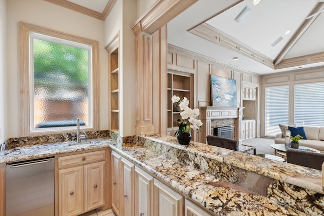 kitchen featuring built in shelves, crown molding, light brown cabinetry, and light stone counters