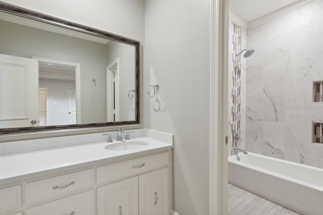 bathroom featuring vanity and tiled shower / bath