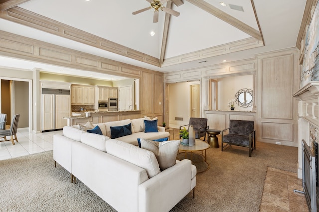 carpeted living room featuring ceiling fan and high vaulted ceiling