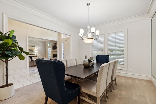 dining room featuring crown molding, light carpet, and an inviting chandelier