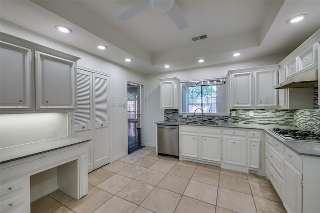 kitchen featuring sink, ceiling fan, appliances with stainless steel finishes, light tile patterned flooring, and white cabinetry