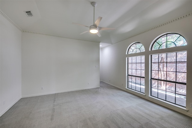 carpeted spare room with ceiling fan and lofted ceiling