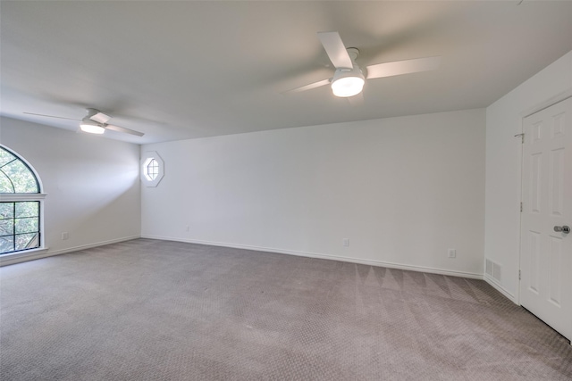 empty room with ceiling fan and carpet floors