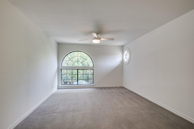 empty room featuring carpet flooring and ceiling fan