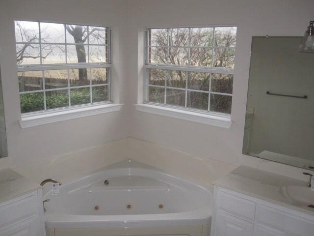 bathroom with a bath and vanity