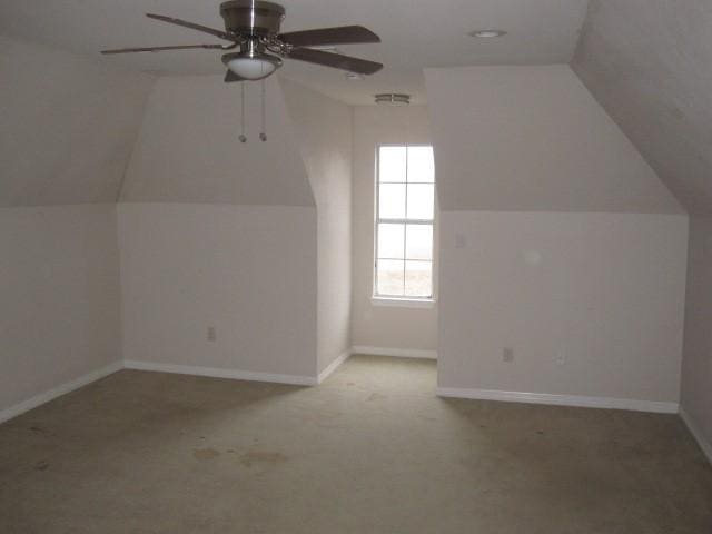 bonus room featuring ceiling fan, light colored carpet, and vaulted ceiling