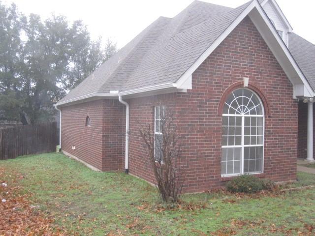 view of property exterior featuring a lawn