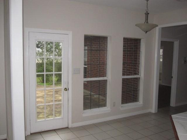 doorway to outside featuring light tile patterned floors