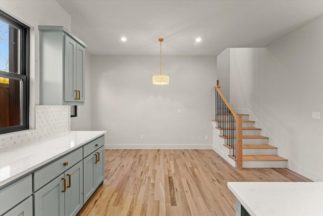 kitchen with decorative light fixtures and light hardwood / wood-style floors