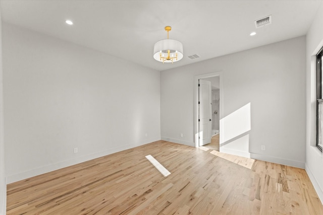 spare room featuring light wood-type flooring