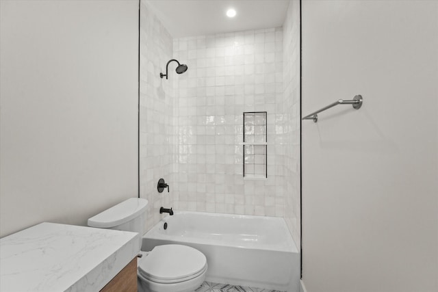 bathroom featuring toilet and tiled shower / bath