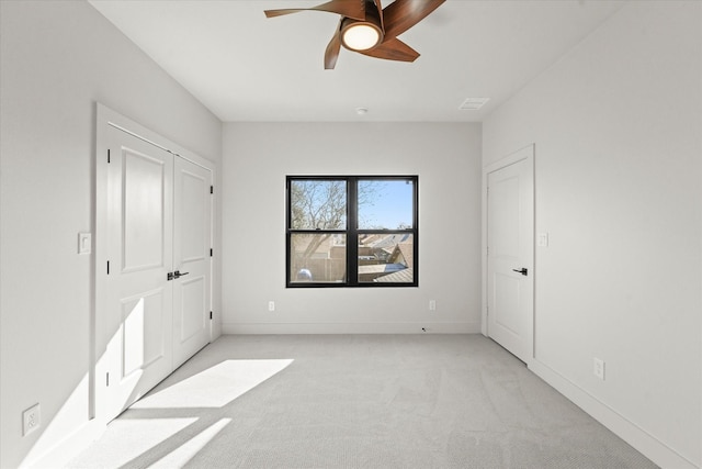 unfurnished bedroom featuring ceiling fan and light colored carpet