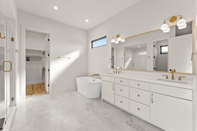 bathroom with vanity and shower with separate bathtub