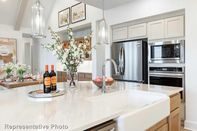 kitchen featuring sink, gray cabinetry, hanging light fixtures, stainless steel appliances, and beam ceiling