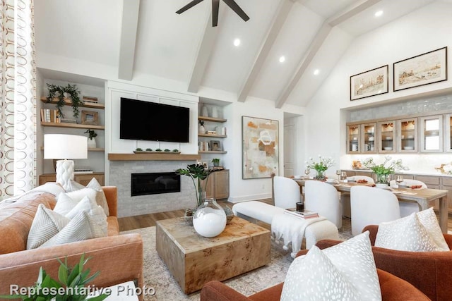 living room with lofted ceiling with beams, ceiling fan, and light hardwood / wood-style floors