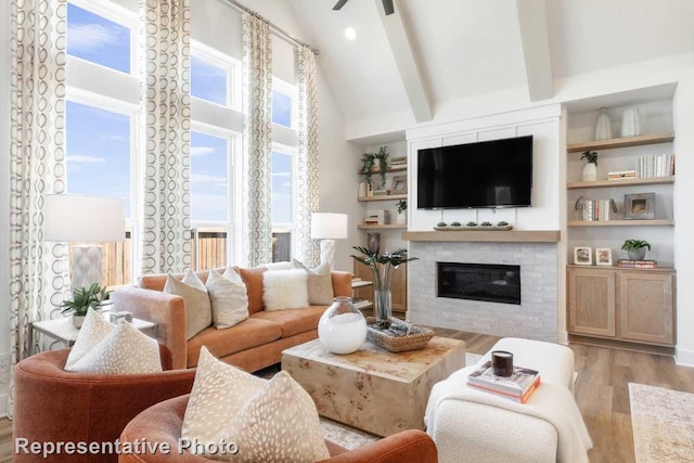 living room with beam ceiling, ceiling fan, light hardwood / wood-style flooring, and high vaulted ceiling