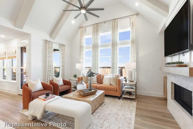 living room with high vaulted ceiling, light hardwood / wood-style flooring, ceiling fan, a fireplace, and beam ceiling