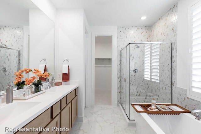 bathroom with vanity and shower with separate bathtub