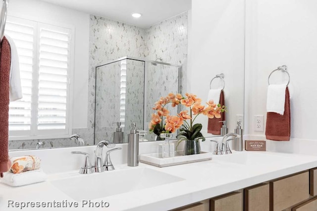 bathroom with vanity and a shower with door