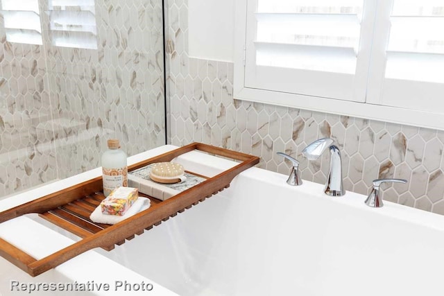 interior details featuring tasteful backsplash and a washtub