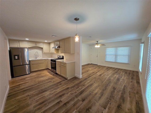 kitchen featuring ceiling fan, sink, dark hardwood / wood-style floors, pendant lighting, and appliances with stainless steel finishes