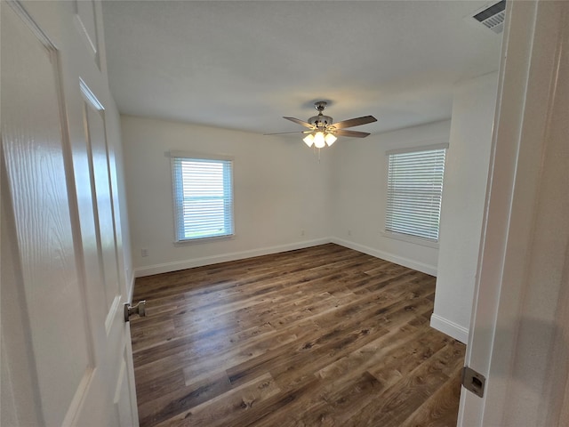 spare room featuring ceiling fan and dark hardwood / wood-style flooring