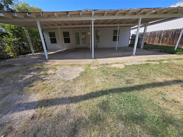 back of house with a yard and a carport