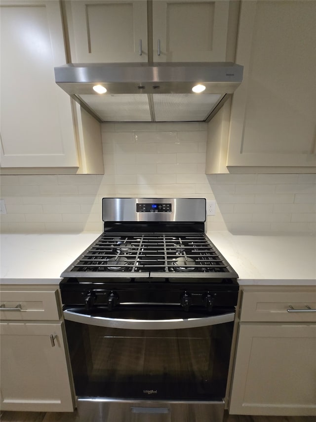 kitchen featuring gas stove and backsplash