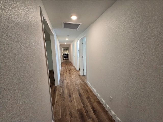 corridor featuring wood-type flooring