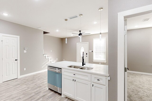 kitchen featuring sink, white cabinets, hanging light fixtures, kitchen peninsula, and stainless steel appliances