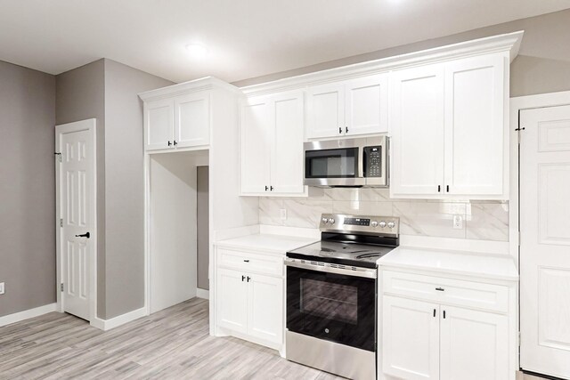 kitchen featuring pendant lighting, sink, appliances with stainless steel finishes, a kitchen island with sink, and white cabinets