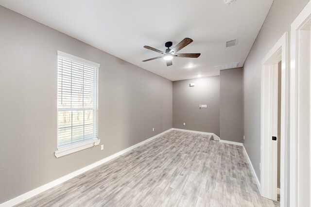 spare room featuring light colored carpet and ceiling fan