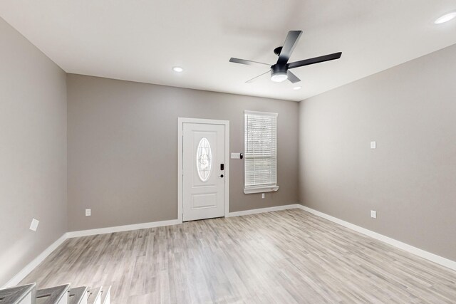 kitchen featuring light hardwood / wood-style flooring, appliances with stainless steel finishes, white cabinetry, hanging light fixtures, and backsplash