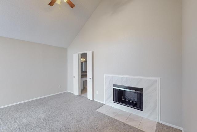 unfurnished living room with light colored carpet, high vaulted ceiling, ceiling fan, and a tiled fireplace