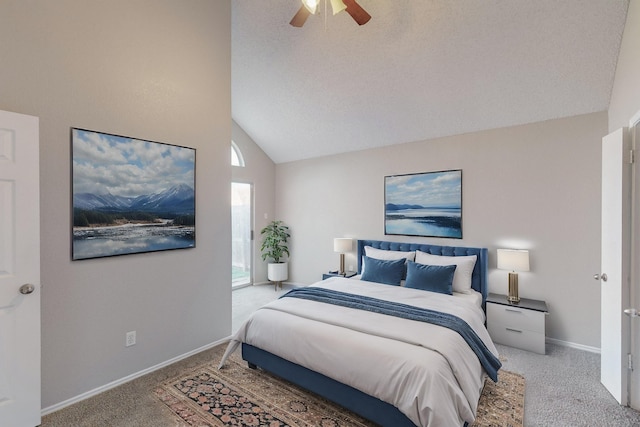 bedroom featuring a textured ceiling, ceiling fan, carpet floors, and vaulted ceiling