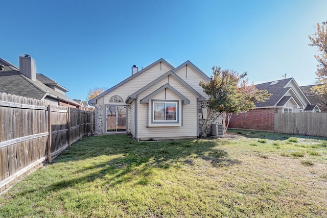 back of house with a yard and central AC unit