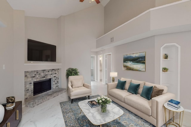 living room with a fireplace and ceiling fan