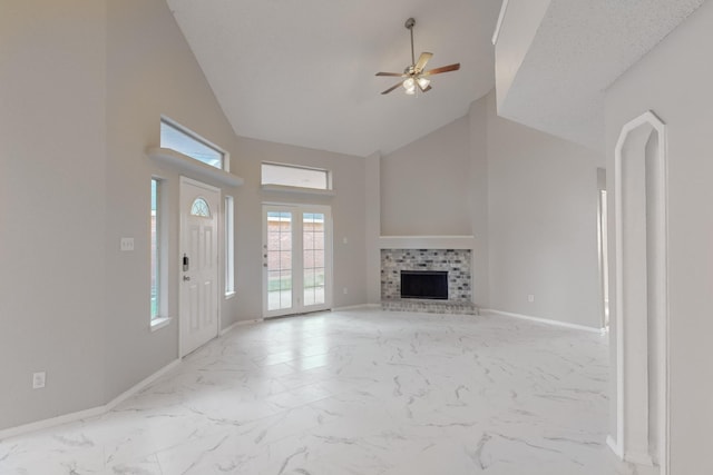 unfurnished living room with a fireplace, high vaulted ceiling, and ceiling fan