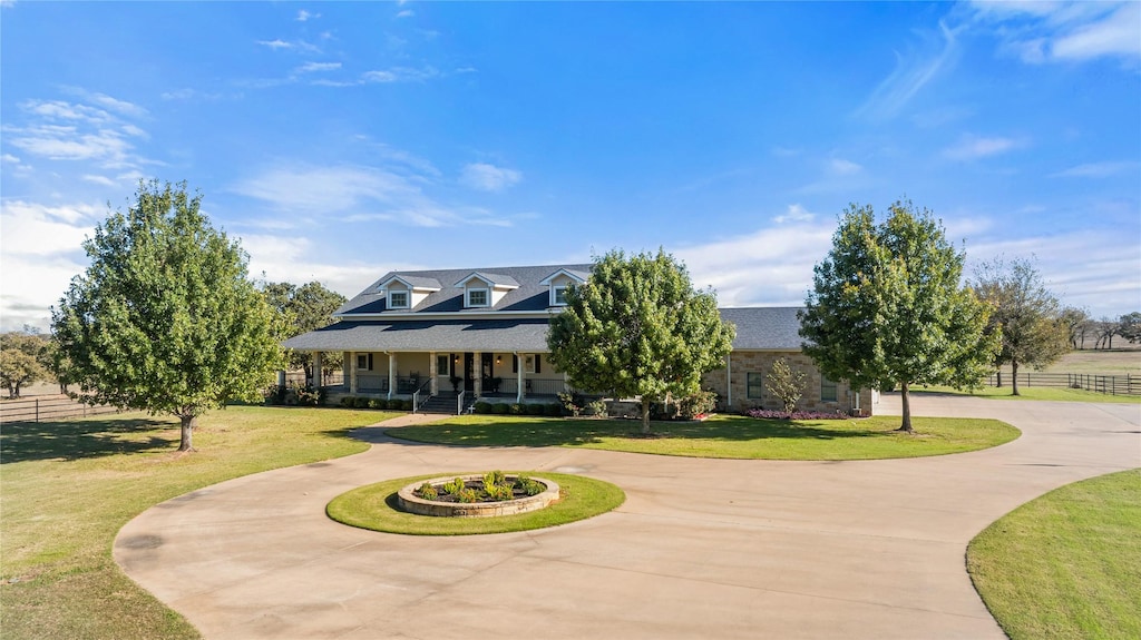 view of front of house with a porch and a front lawn