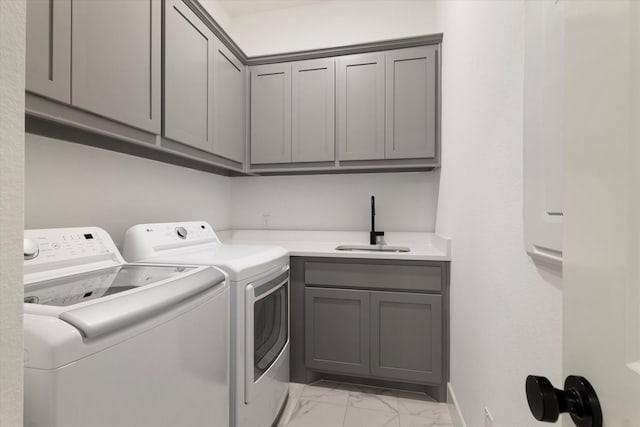 washroom featuring cabinets, separate washer and dryer, and sink