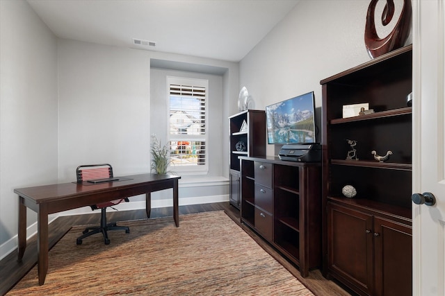 office with visible vents, baseboards, and dark wood-style floors