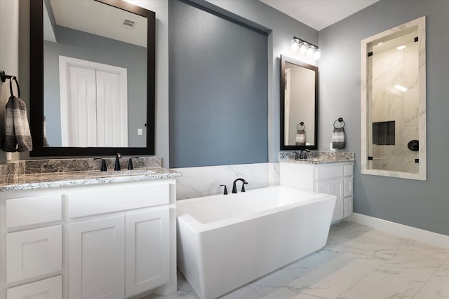 bathroom featuring baseboards, two vanities, tiled shower, a freestanding tub, and marble finish floor