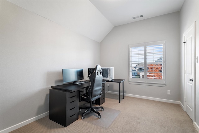 office area featuring vaulted ceiling, visible vents, baseboards, and carpet floors