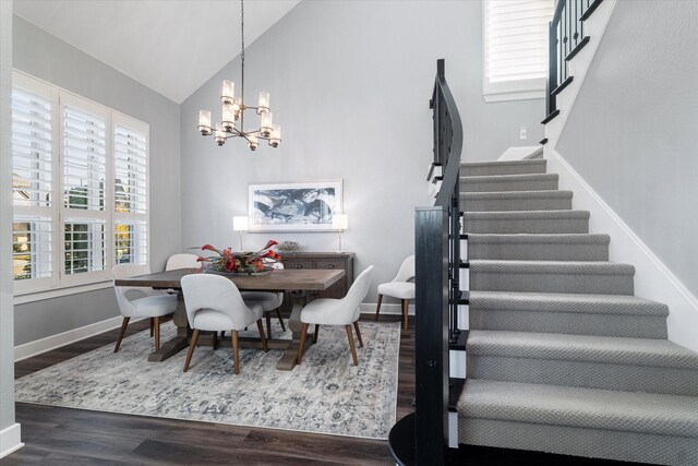 foyer entrance featuring french doors, dark hardwood / wood-style flooring, and a notable chandelier