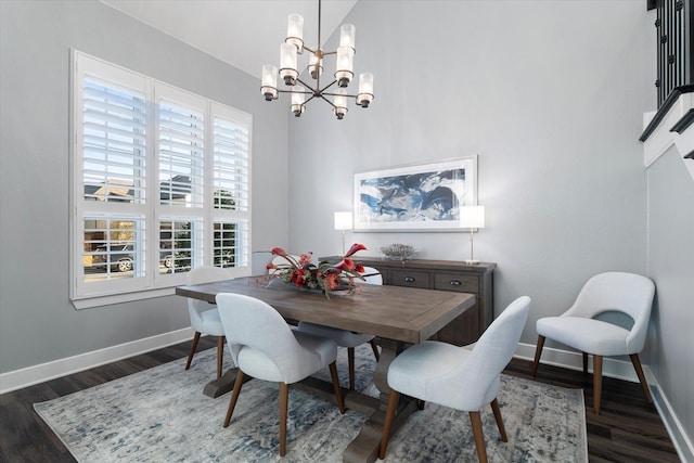 dining room featuring dark wood-style floors, a notable chandelier, and baseboards