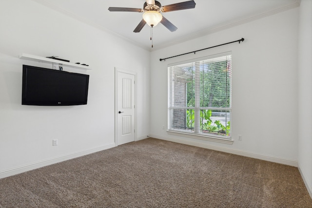 empty room featuring crown molding, ceiling fan, and carpet