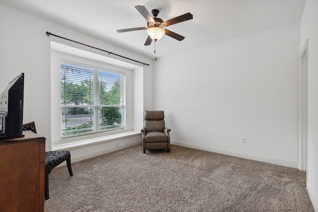 living area with carpet flooring and ceiling fan