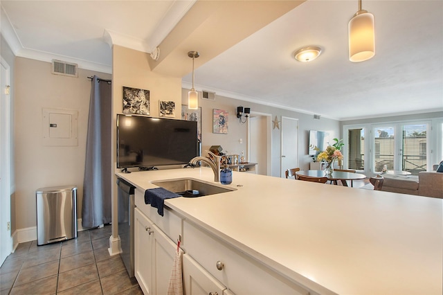 kitchen with decorative light fixtures, light countertops, visible vents, white cabinetry, and a sink