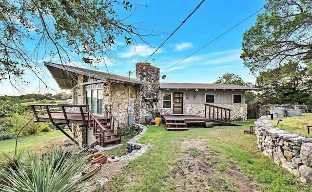 rear view of property with a yard and a deck