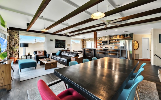 dining area featuring a healthy amount of sunlight, ceiling fan, and dark wood-type flooring